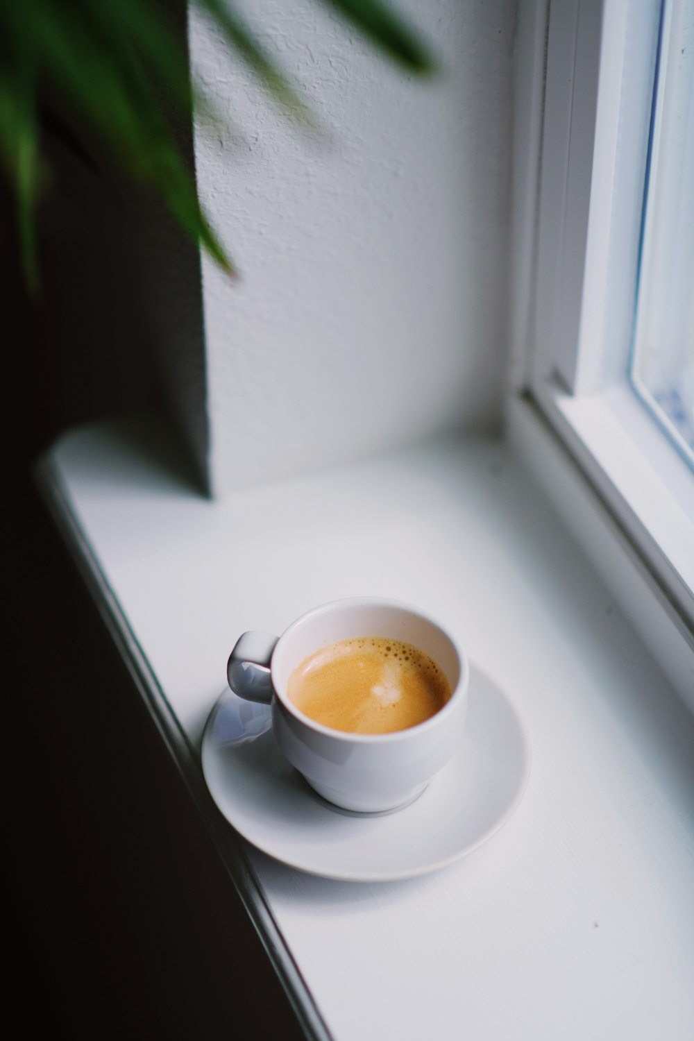 white ceramic cup on white saucer