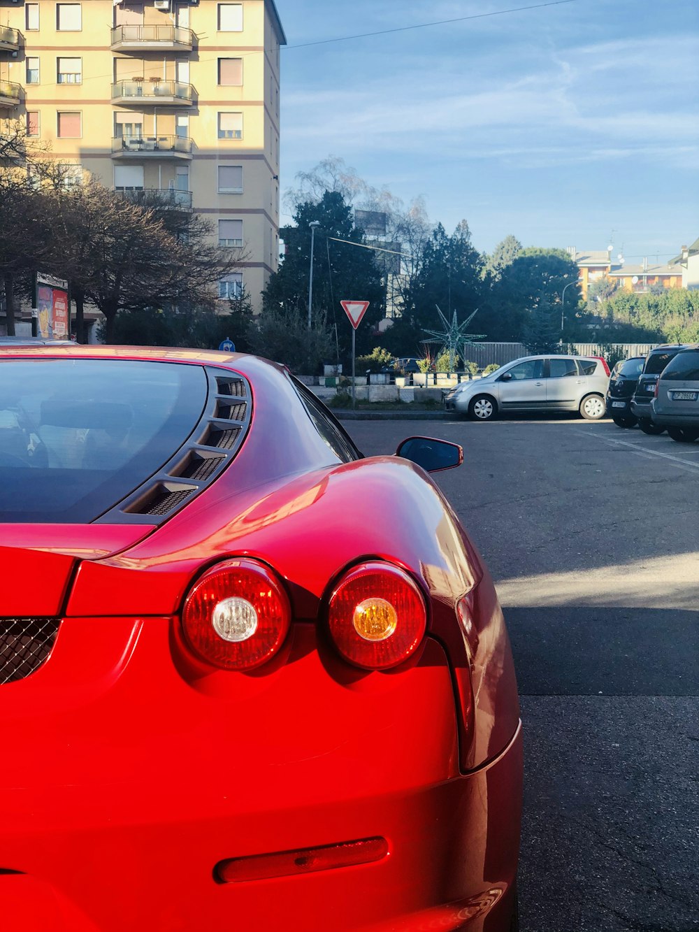 red ferrari car on road during daytime