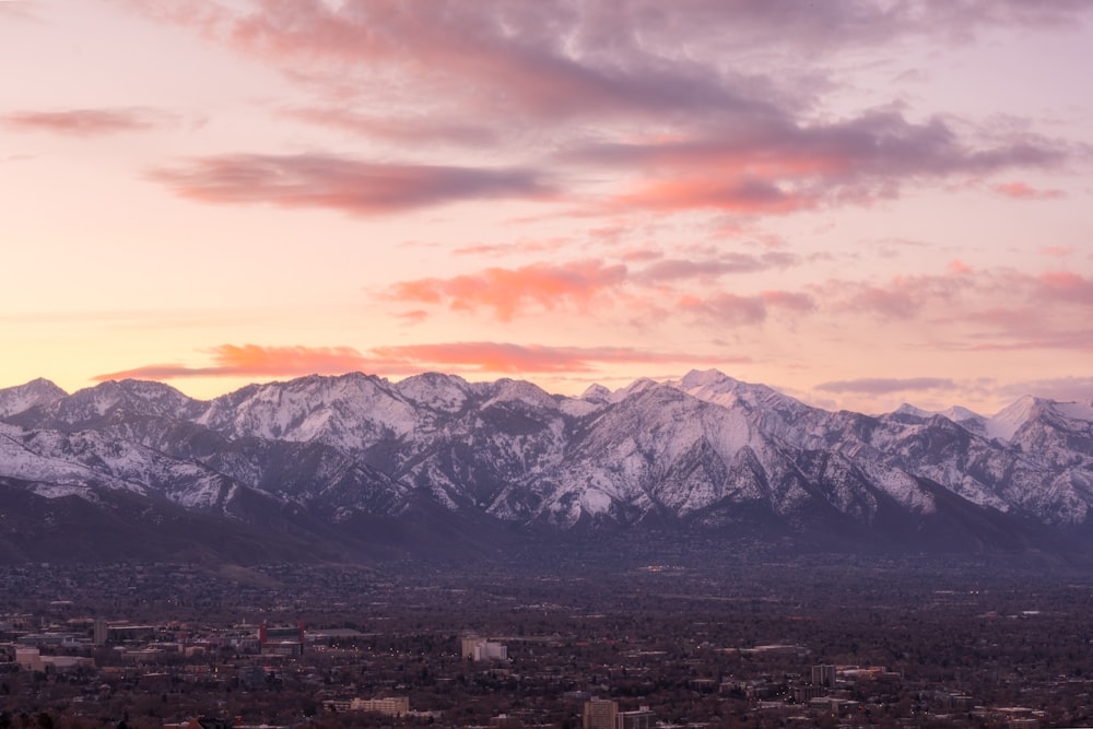 snow covered mountains under cloudy sky during daytime