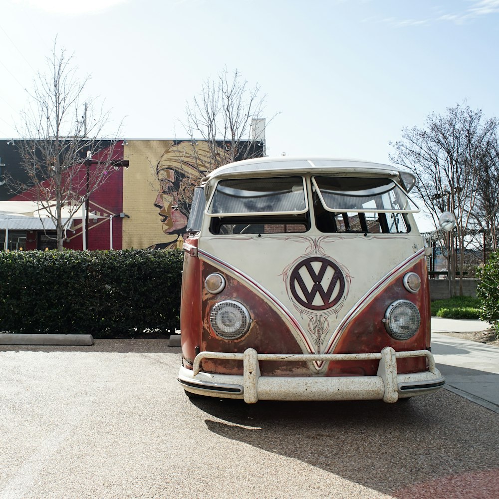 red and white volkswagen t-2 van parked on gray concrete road during daytime