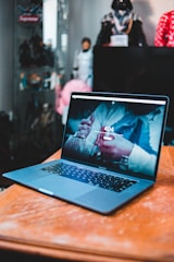 black laptop computer on brown wooden table