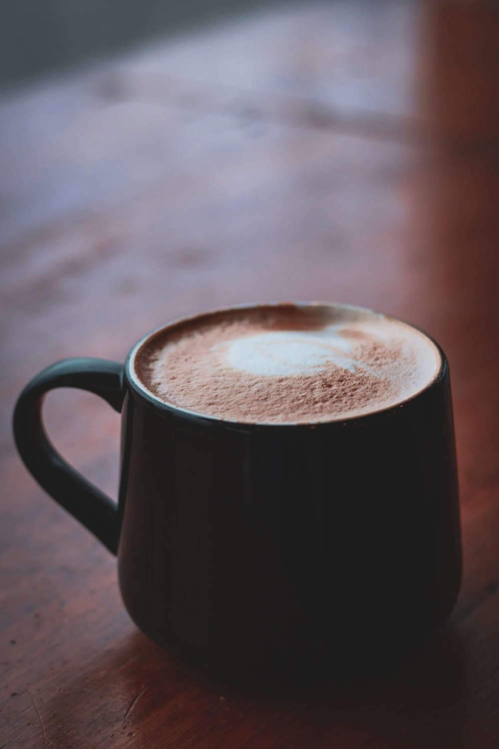 brown ceramic mug with brown liquid