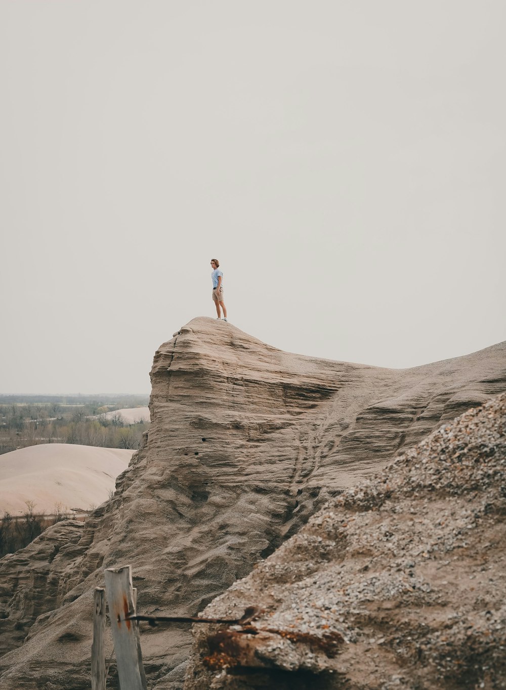 person standing on brown rock formation during daytime