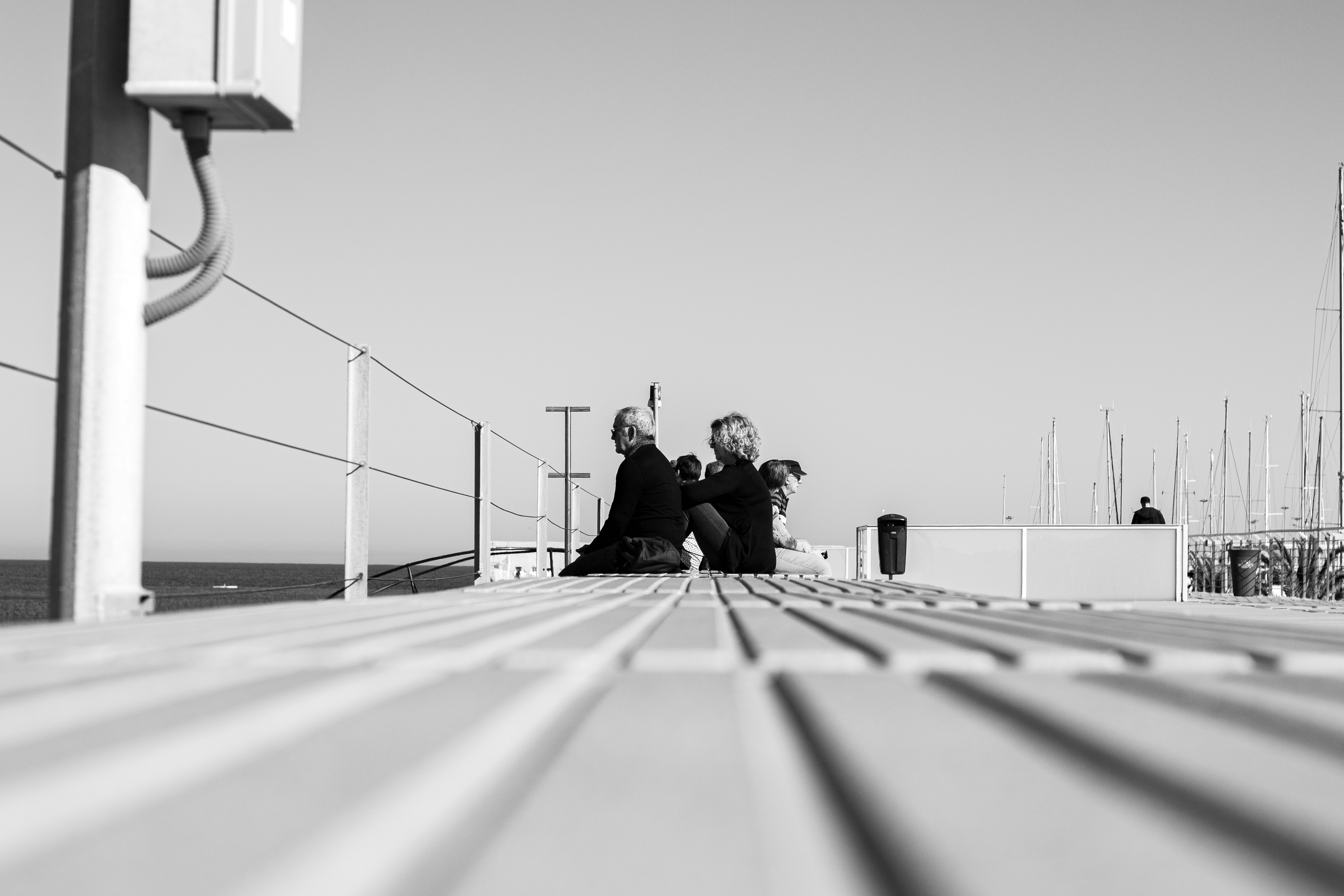 man and woman sitting on concrete bench