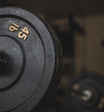 black and gray dumbbell on black surface