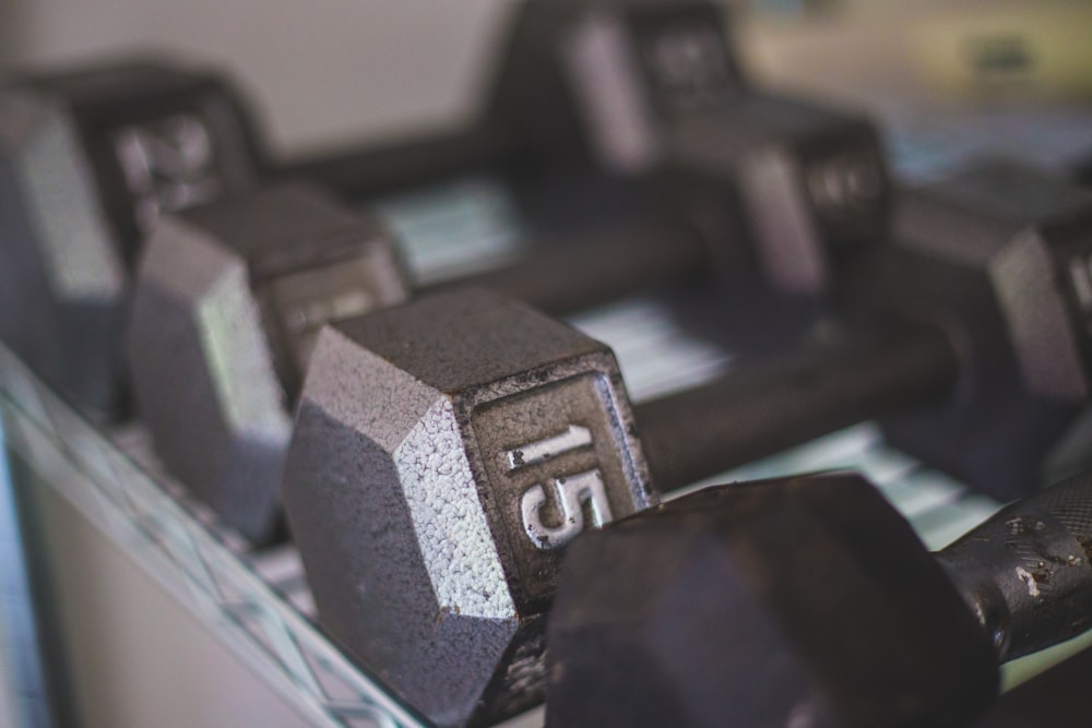 black dumbbells on white table