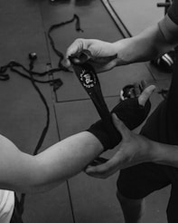 grayscale photo of person holding a microphone