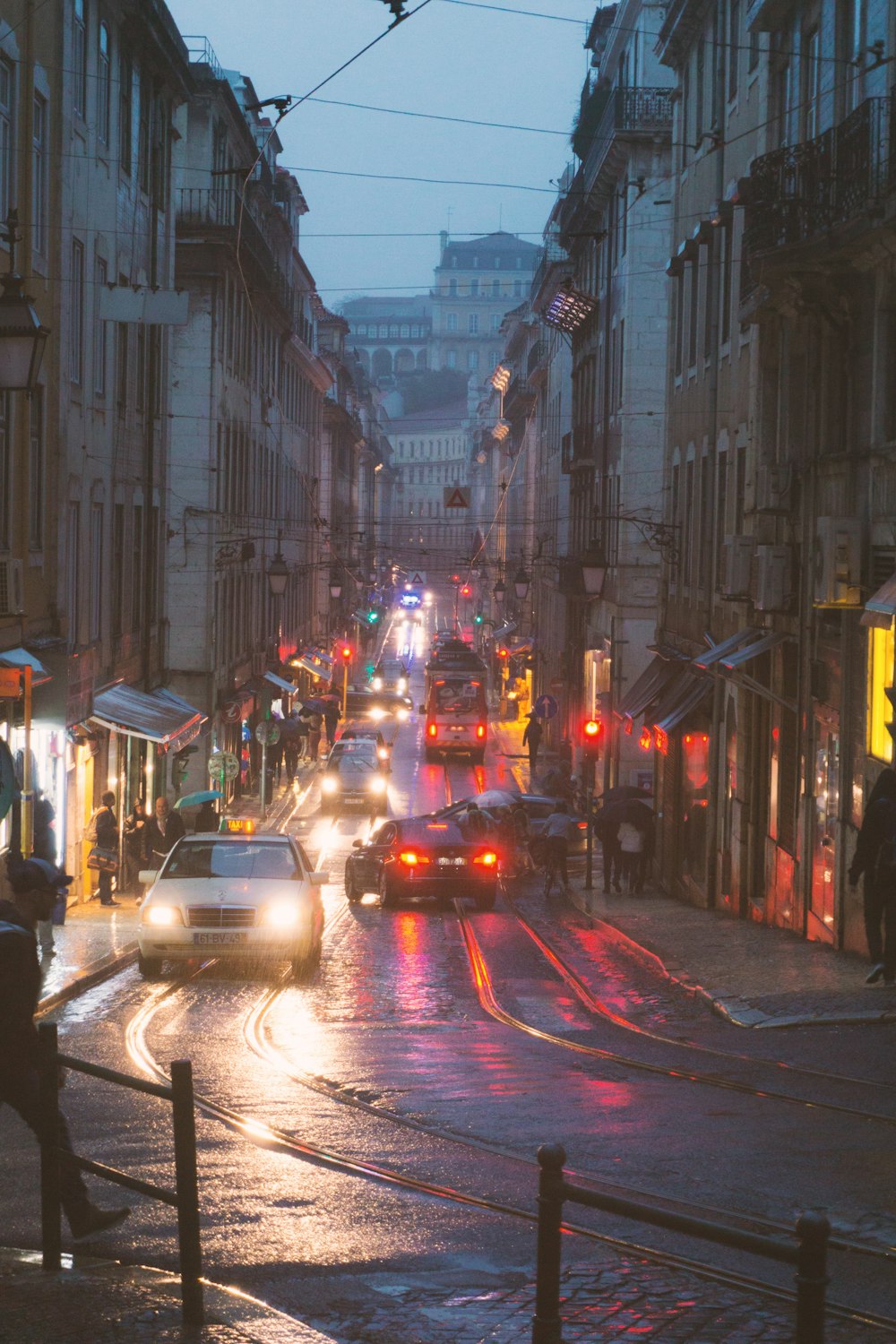 cars on road between buildings during night time