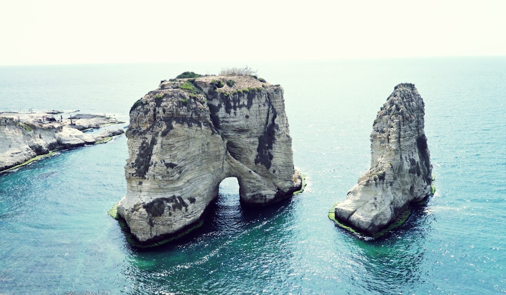 brown rock formation on sea during daytime