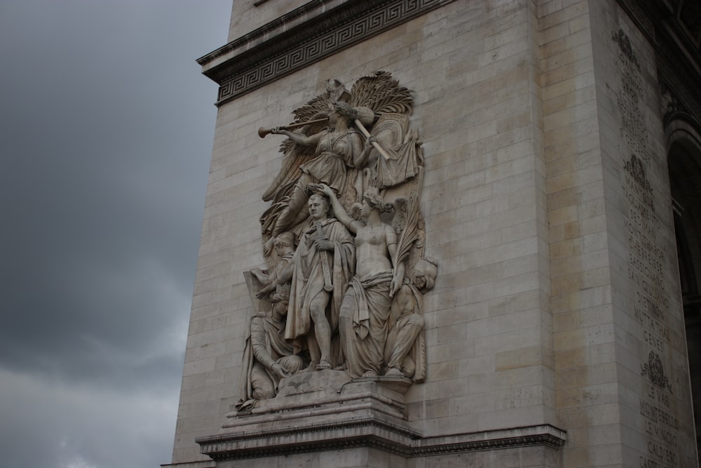 white concrete statue under white sky during daytime