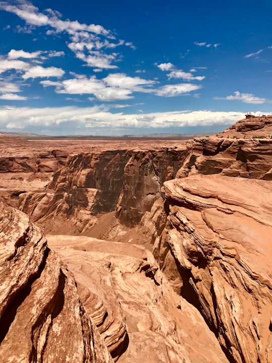 brown rocky mountain under blue sky during daytime in Horseshoe Bend United States