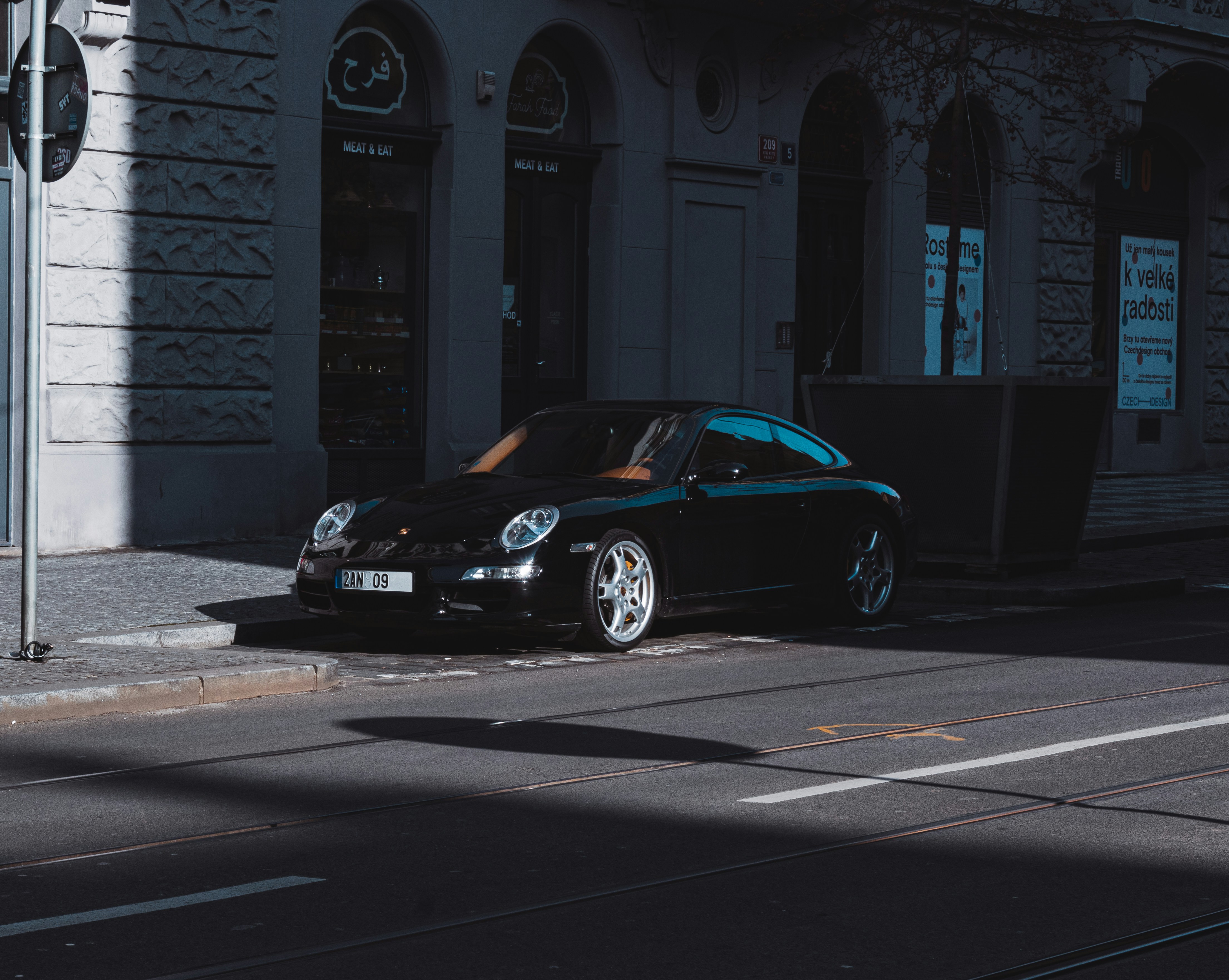 black porsche 911 parked near white concrete building during daytime czechia zoom background