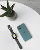 A tasteful arrangement of gold coins and a sleek smartphone showing a webinar countdown timer.