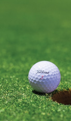 white golf ball on green grass field during daytime