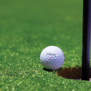 white golf ball on green grass field during daytime