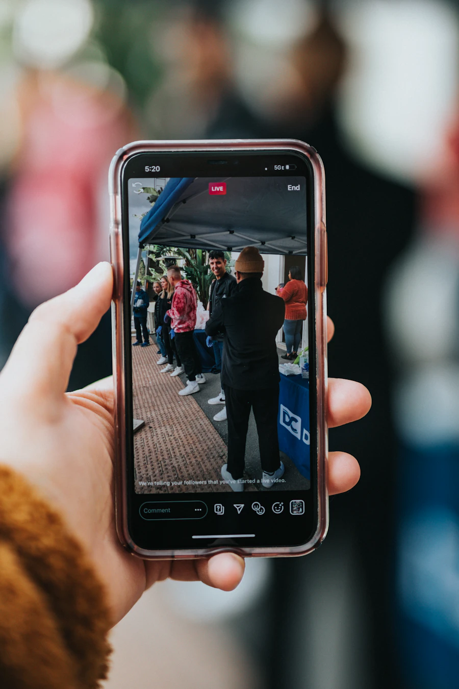 Creator holding a smartphone mid-stream
