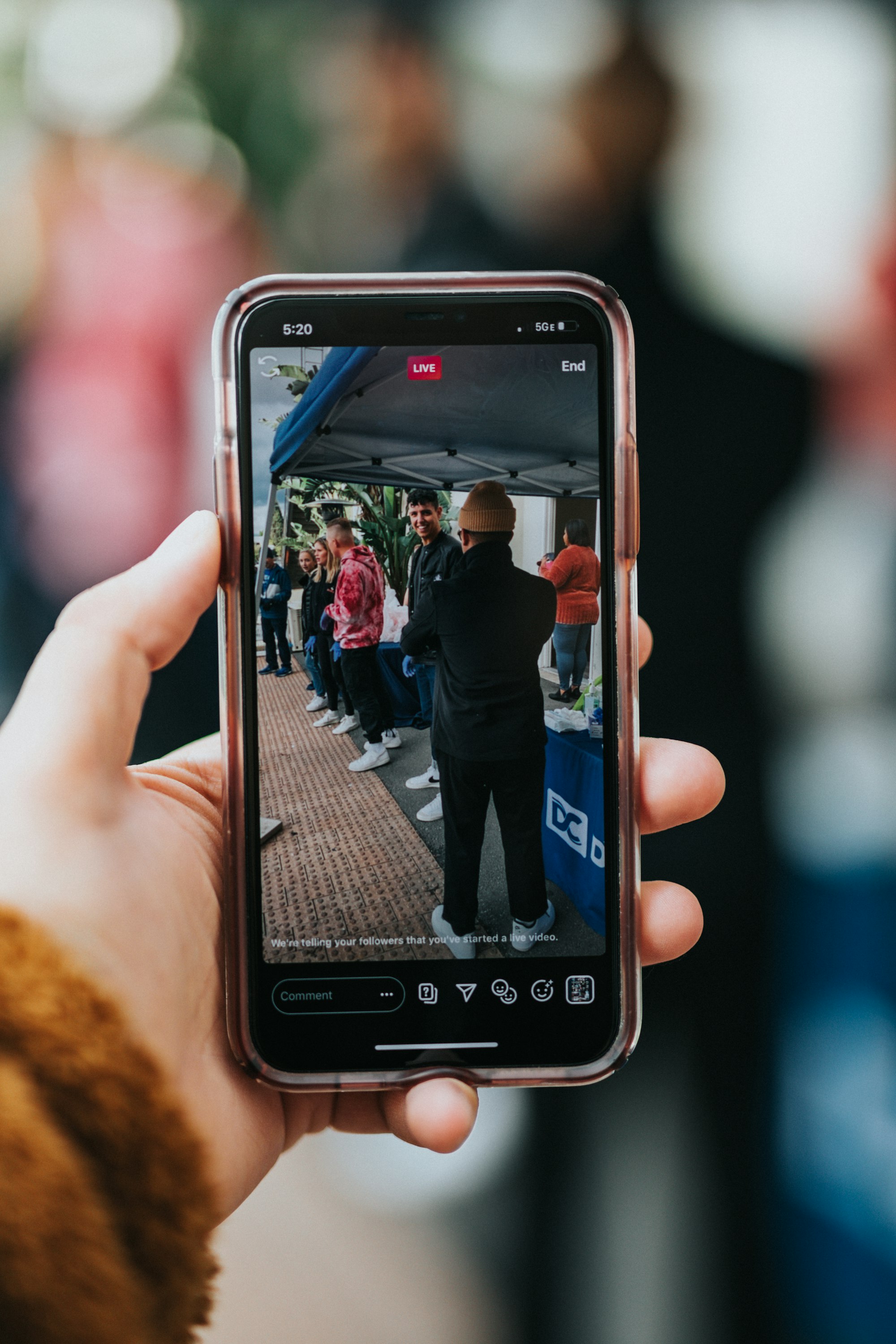 person holding phone, recording vertical video