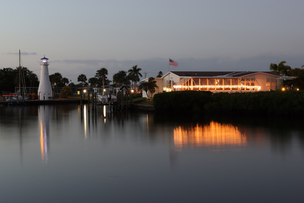 white and brown house near body of water during night time