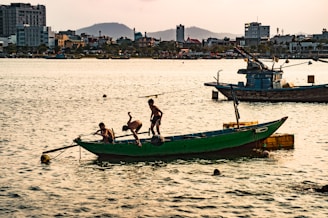 Children playing on the boat’s deck with the sparkling Mediterranean in the background.