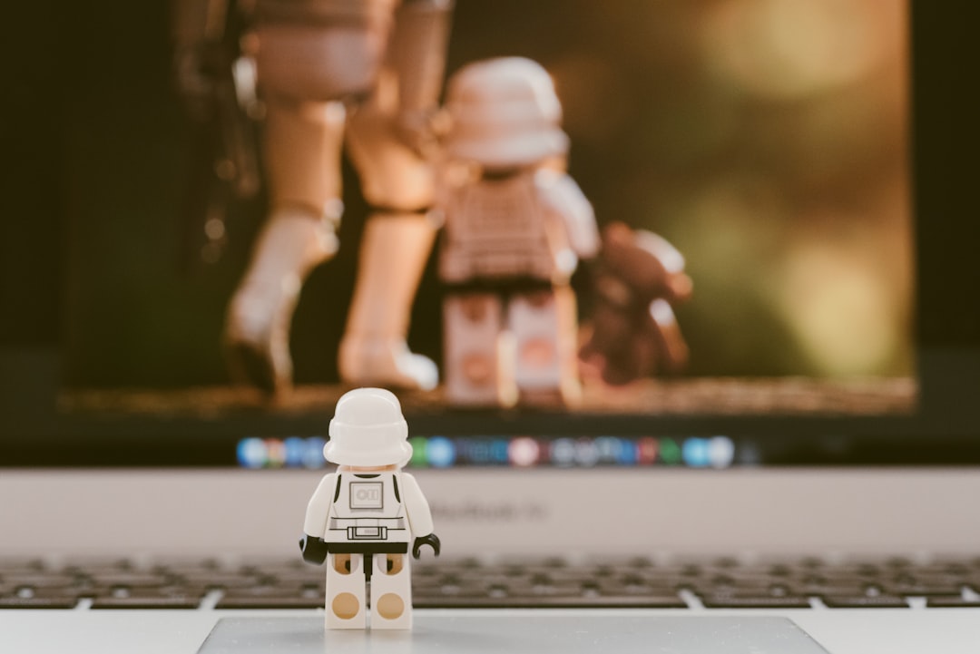 lego minifig on white and black laptop computer