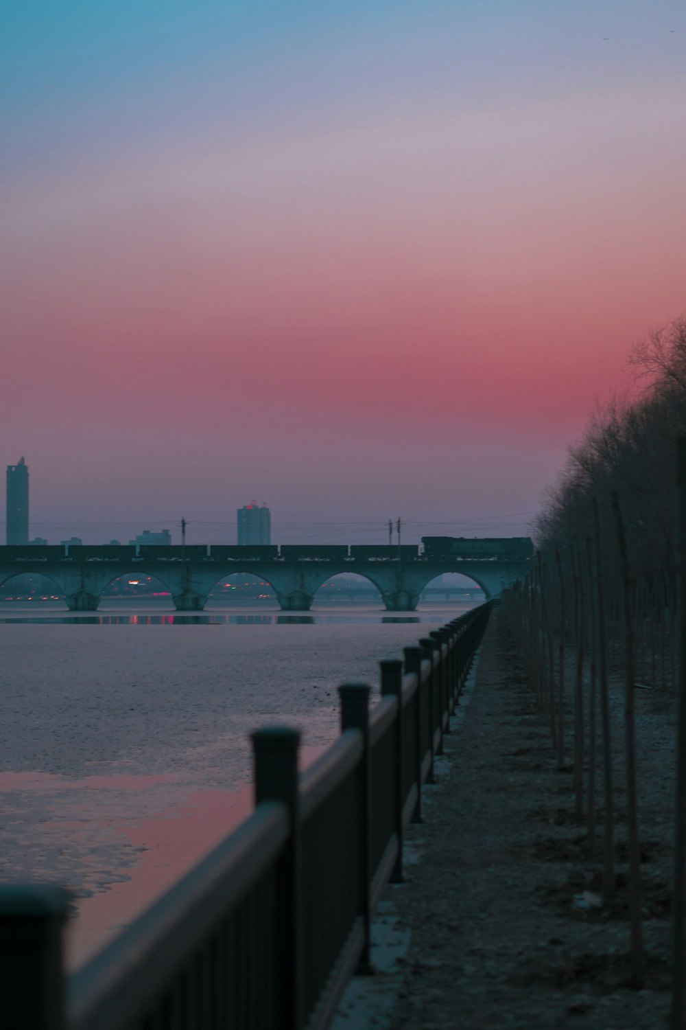 bridge over water near city buildings during daytime