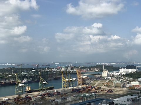 A panoramic view of the bustling Port of Casablanca with cargo ships and cranes under a clear sky.