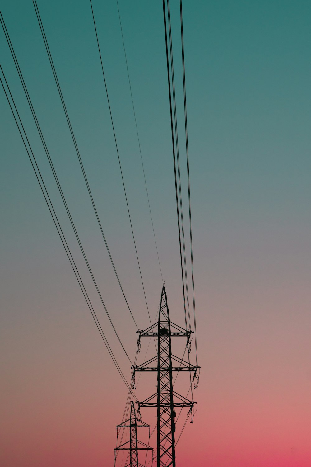 black electric post under blue sky during daytime