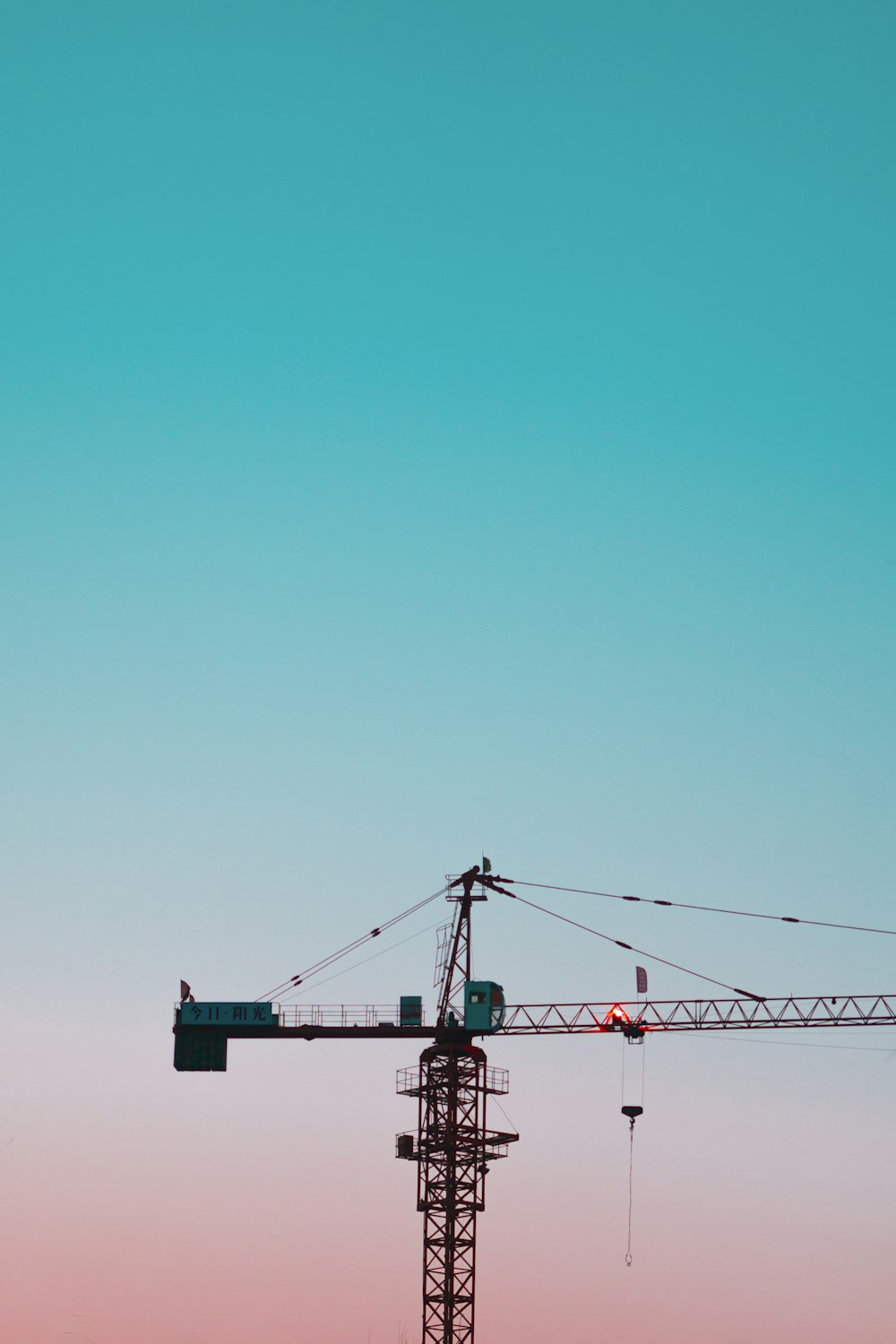 red and blue crane under blue sky during daytime