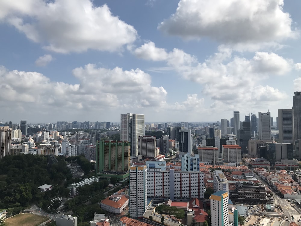 city buildings under white clouds during daytime