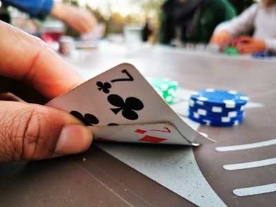 Close-up of a player winning a rummy hand with chips and cards on the table.