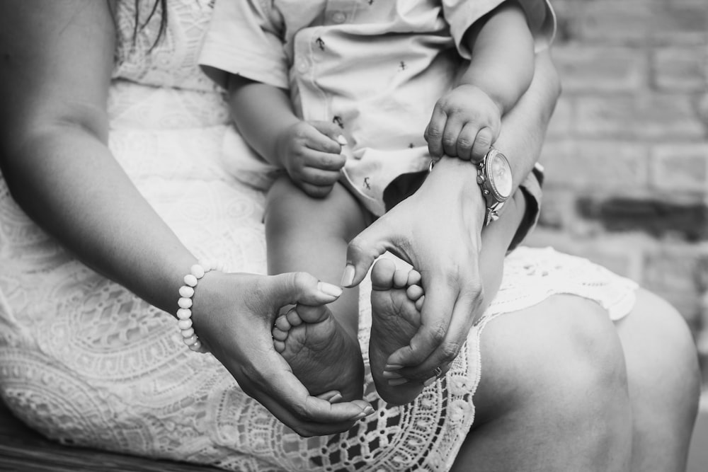 grayscale photo of woman holding baby