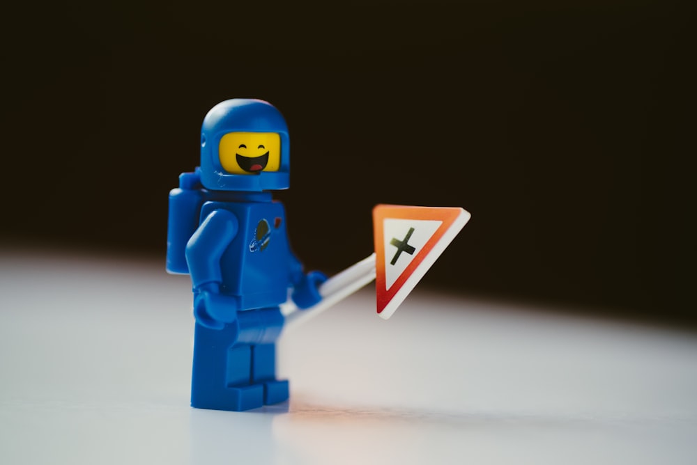 blue lego minifig on white surface