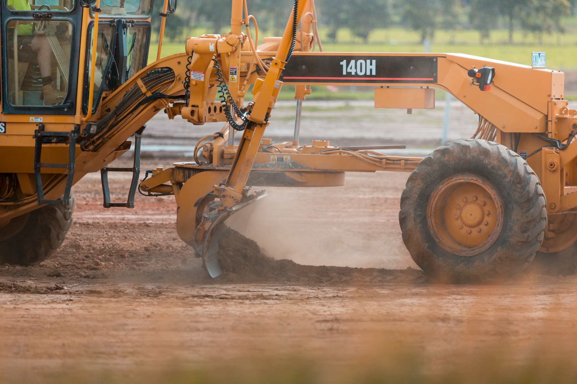 Grader Heavy Vehicle at work on residential estate construction site.