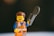 A happy customer holding a LEGO set with the Brickdex app open on their phone.