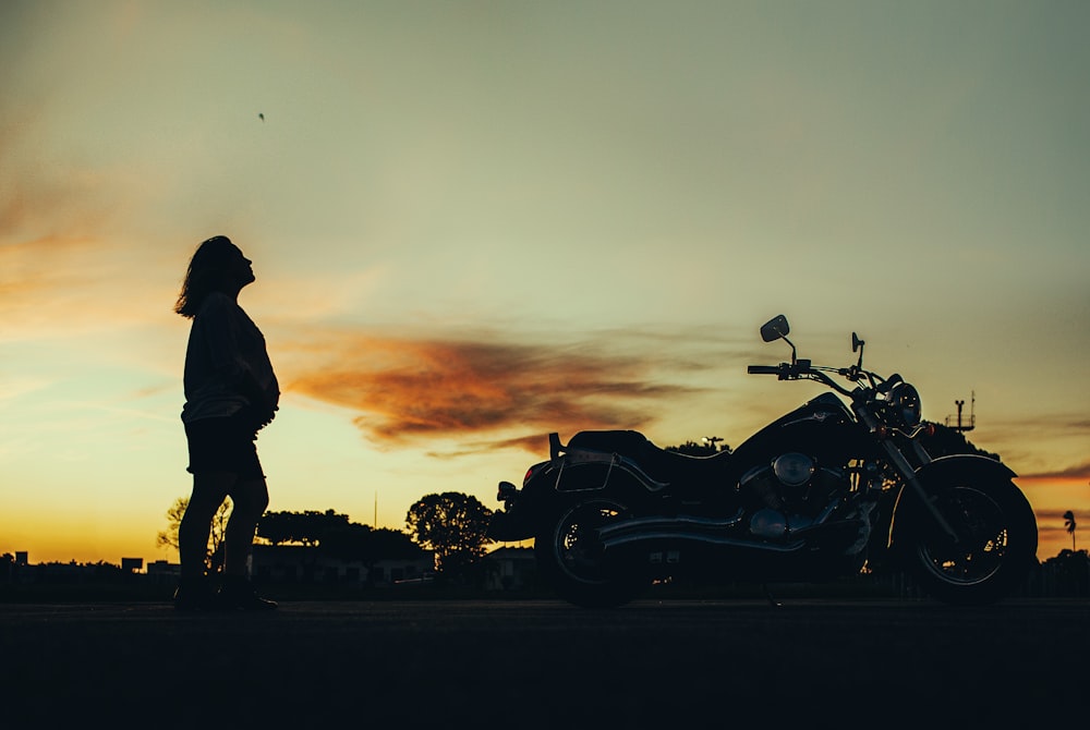 silhouette of man riding motorcycle during sunset