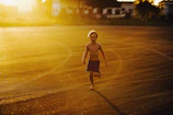 A cinematic shot of children playing joyfully in warm, golden hour sunlight.