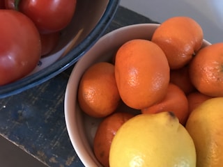 Close-up of vibrant frozen fruit pulps in colorful bowls on a rustic wooden table