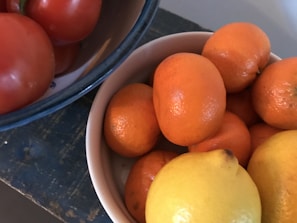 Close-up of vibrant frozen fruit pulps in colorful bowls on a rustic wooden table