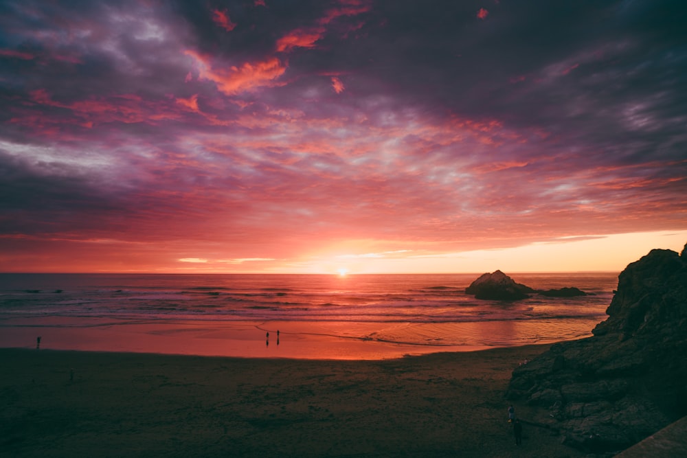 silhouette of people on beach during sunset