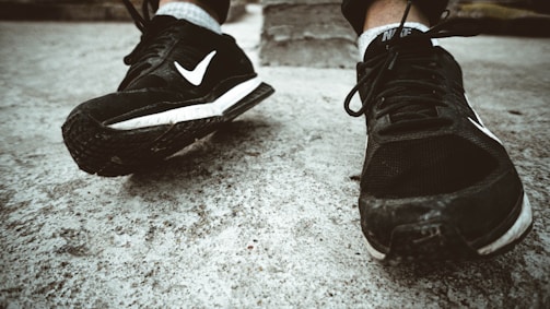 Close-up of worn-out shoes replaced by fresh sneakers on a young athlete.