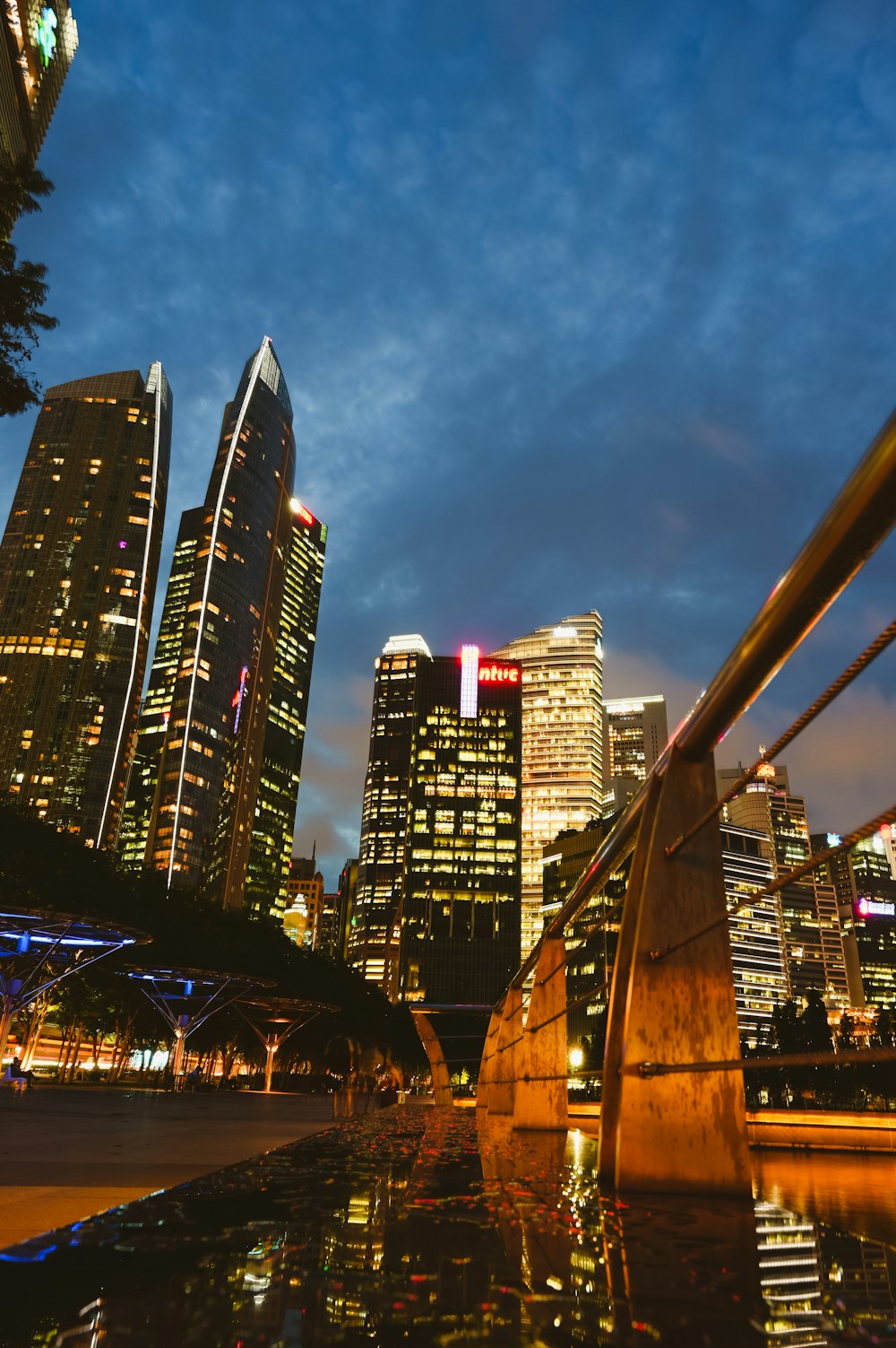 high rise buildings near bridge during night time