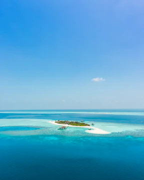 A tranquil secret island with crystal-clear turquoise waters and lush greenery.