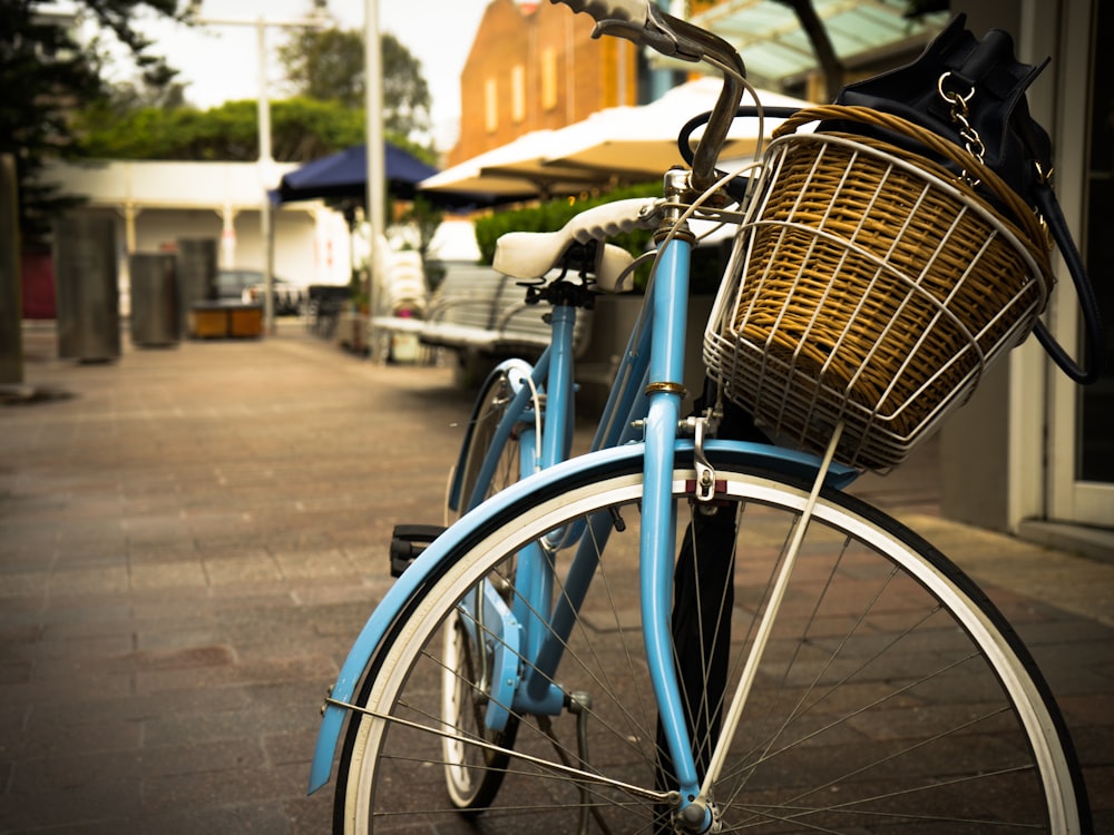 blue city bike parked on sidewalk during daytime