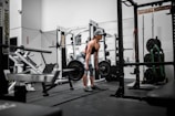 man in orange tank top and black shorts doing exercise