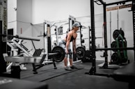man in orange tank top and black shorts doing exercise