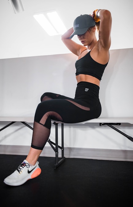 Close-up of black leggings with sheer mesh panels on the thighs