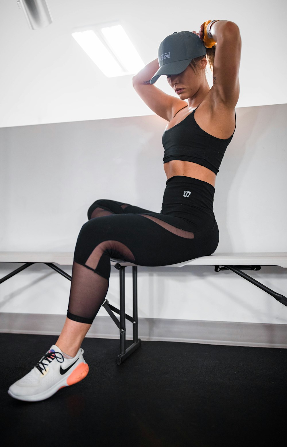 woman in black sports bra and black leggings doing yoga