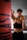 woman in black sports bra and black shorts holding orange bottle