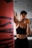 woman in black sports bra and black shorts holding orange bottle