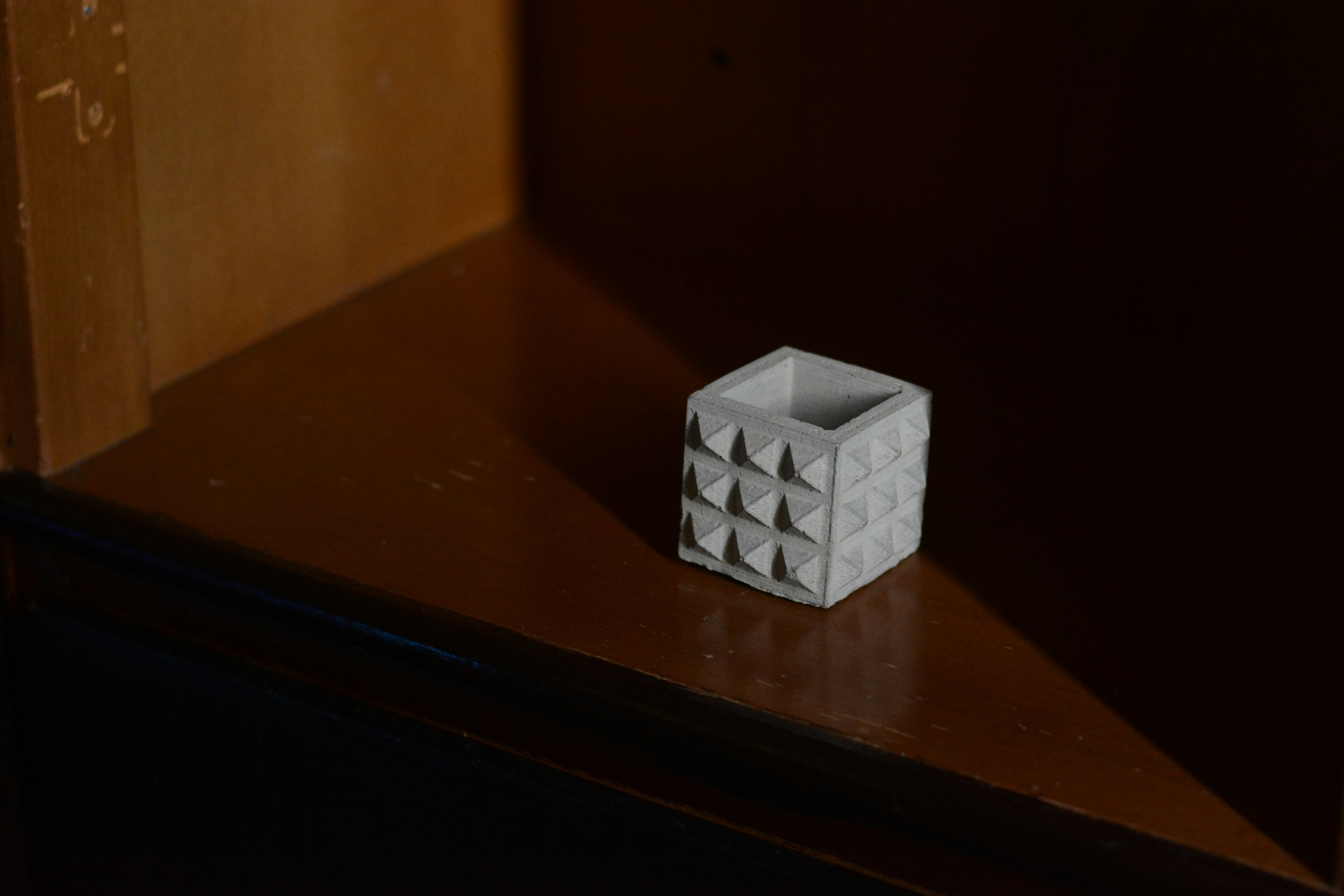 white and black checkered cube on brown wooden table